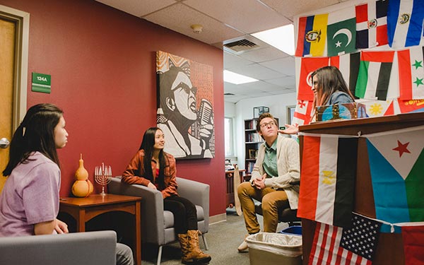 students relax in chairs on campus