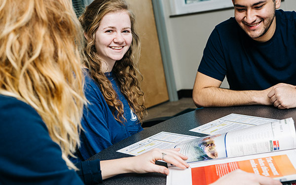 students smiling while studying together