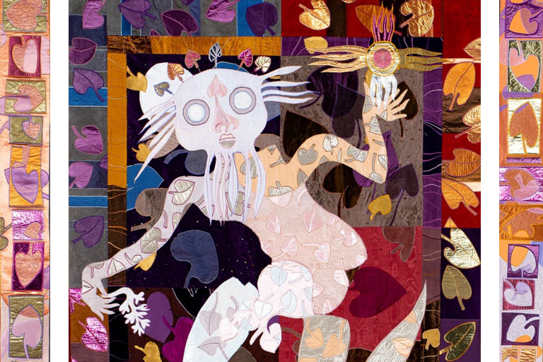 detail of quilt by Ken Phillips "From the Enchanted Island_Catulpa Tree Spirit" showing a human-like figure with flowing beard and hair wearing a crown of leaves and covered in leaf patters holding a sun