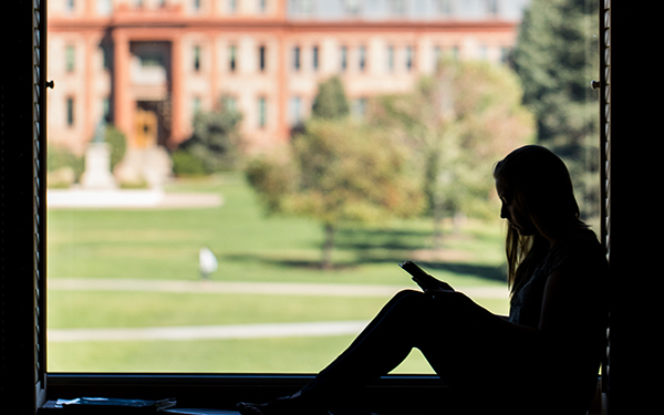 student in window at Library