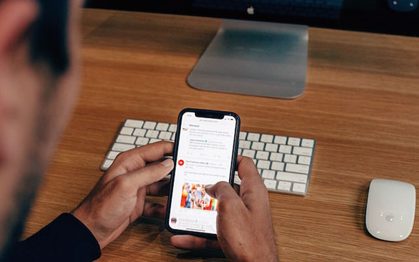 man reads news on smartphone