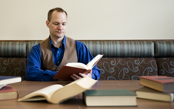 faculty reading books at table