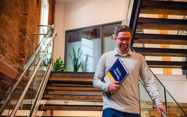 young professional man descends stairs