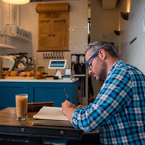 Regis graduate student in coffee shop