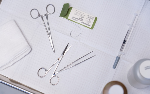Gaus, two medical scissors and hypodermic needle