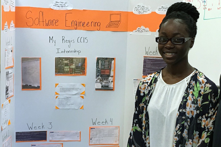 Michela Puni Nimako stands in front of her internship project