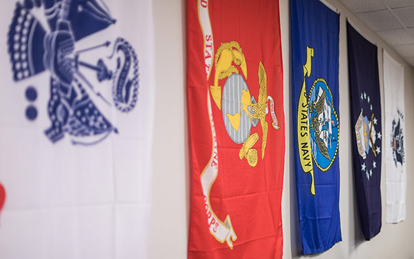Military branch flags on the wall