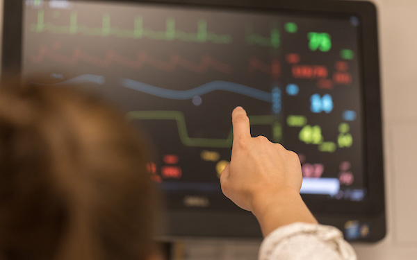 nurse points to heart monitor