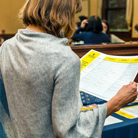 woman examines a document at nurses night out event