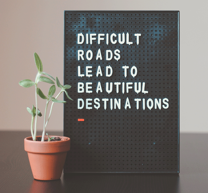 sign reading "difficult roads lead to beautiful destinations"