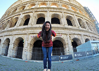 student in front of architecture during study abroad 