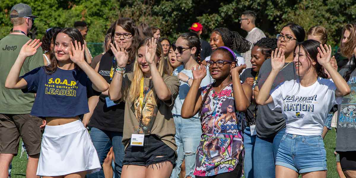 Students dancing and celebrating together during a lively orientation event.