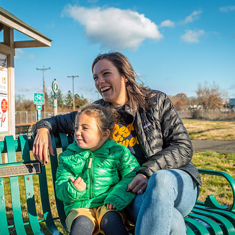 Regis mother sitting on a bench with her child