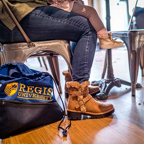 view of the feet or a woman and a toddler under the table of a coffee shop