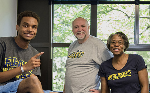 Student moving in to the dorms with the help of his parents