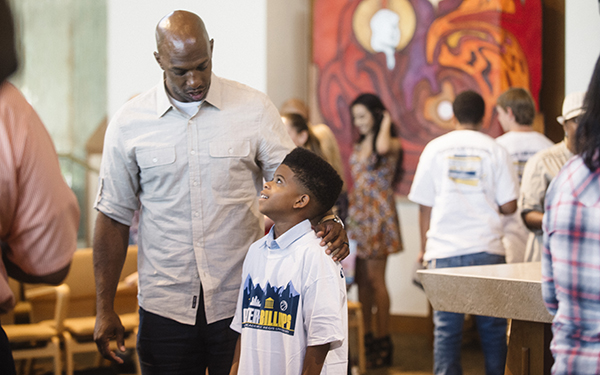 Chauncey Billups puts his hand on young boy's shoulder