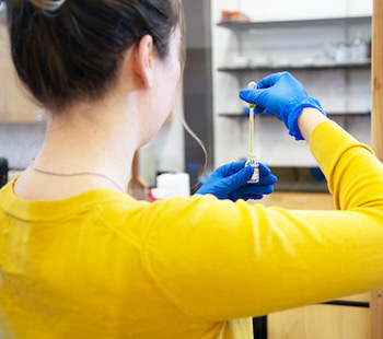 a Regis student measures medication at the Clinical Sim lab in Thornton