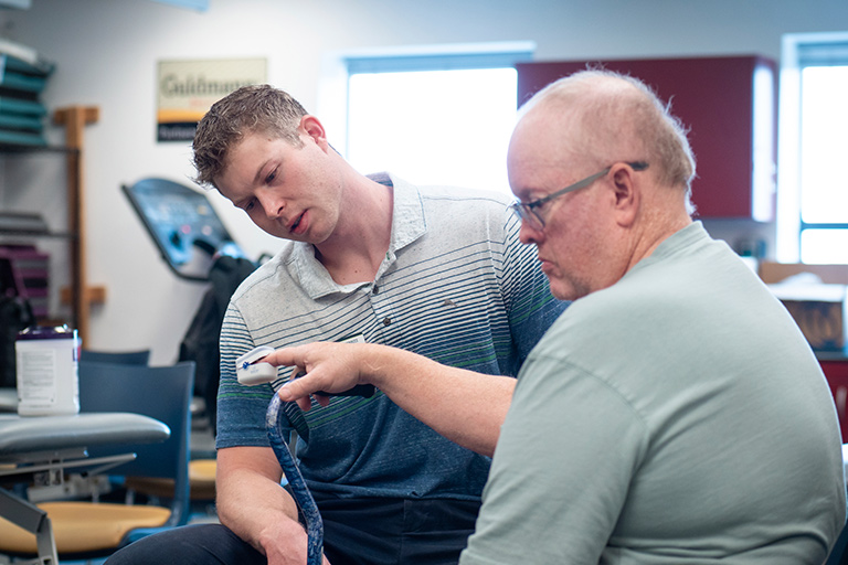 a Regis physical therapy student takes the vitals of a patient in the simulation lab in Thornton, Colorado
