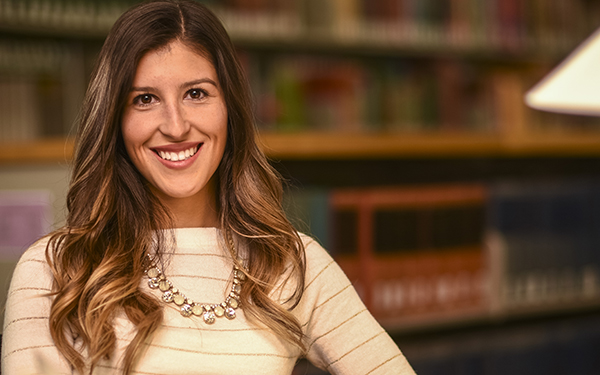 professional-looking woman smiles in library