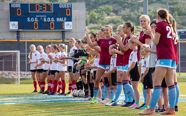 rapids youth participants applaud during game