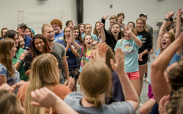 Excited students cheer in a large group