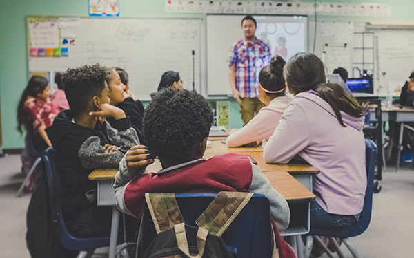 teacher with young students in classroom