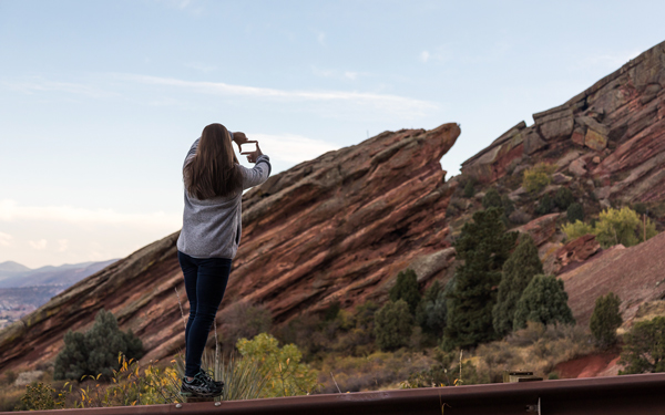 Student taking a photo of Red Rocks formations in Colorado
