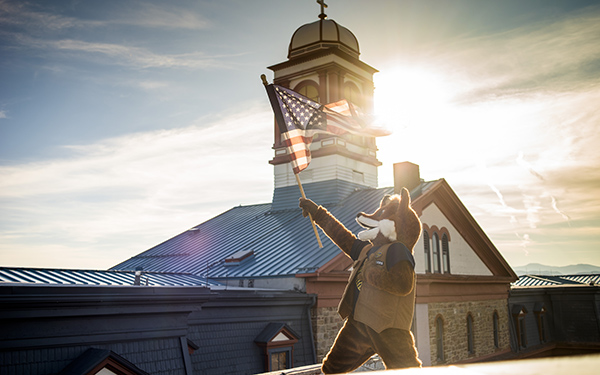 regi waving flag in front of main hall