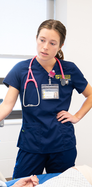 Nursing students assessing a patient and recording observations during clinical training