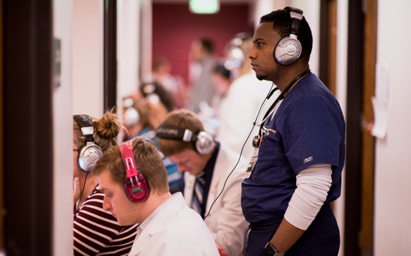 Regis University students participating in a clinical training activity using audio simulation