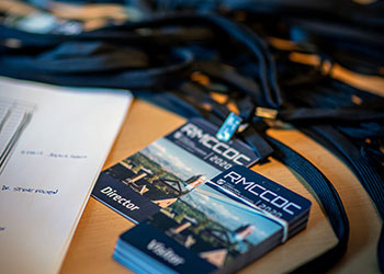 badges to the event sit on a table