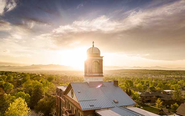 sun sets behind Main Hall cupola