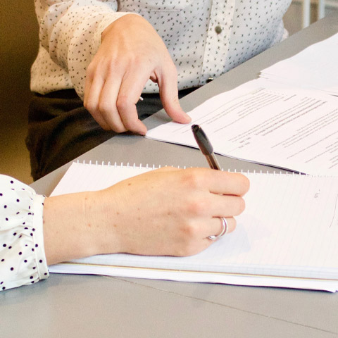 person writing on notebook