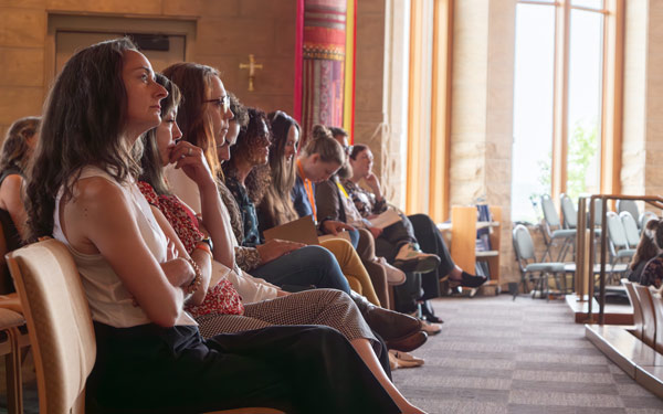 Students and community members seated and listening during a diversity and equity network conference.