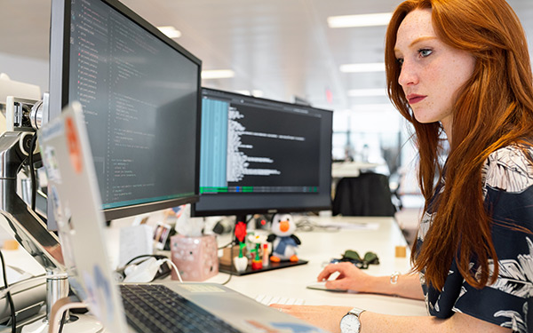 Woman coding at computer