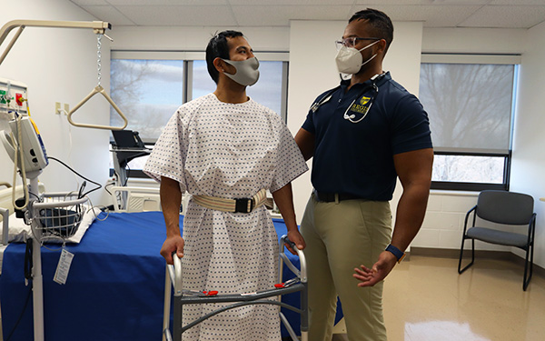 Regis student with a patient