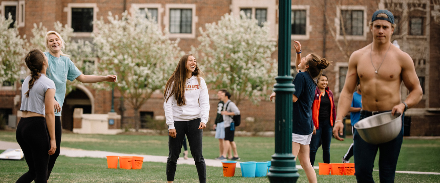 Students enjoying a lawn game and spending time together on campus
