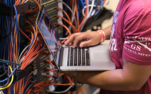 Student in the server room located at the Denver Tech Center