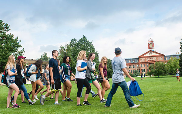 A group of students walking across the quad