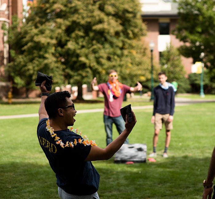students play hacky sack on the Regis Quad