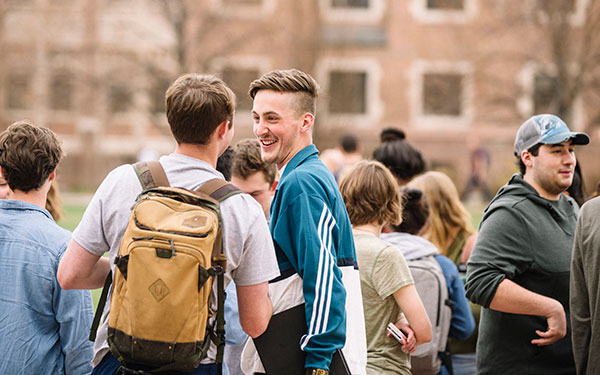 students hanging out on the quad laughing