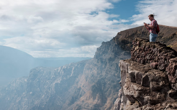 student on cliff during spring break trip