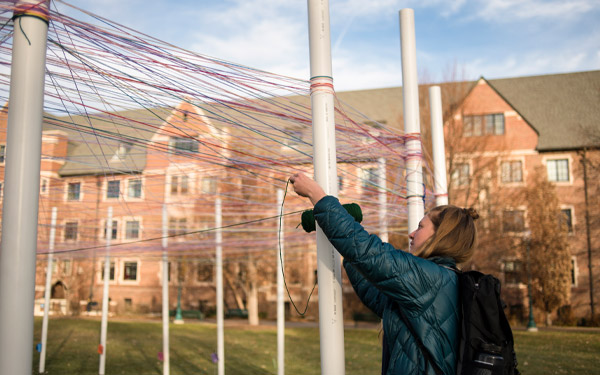 student participates in social justice week installation