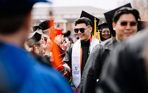 graduates line up outdoors at commencement