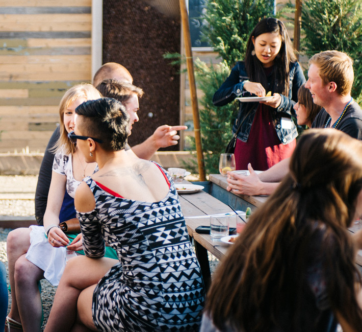 group of people gathered at outdoor seating area in conversation