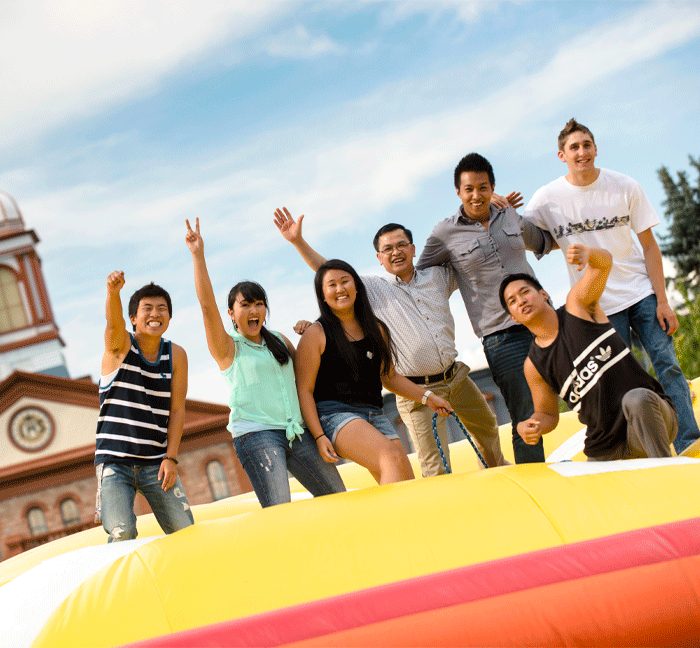 group of students on inflatable outside Main Hall