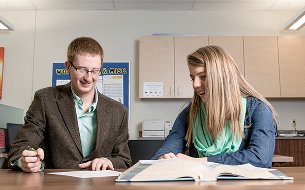 Students studying together with textbooks