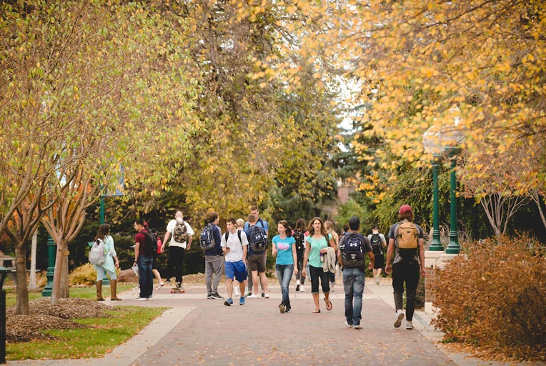 Students walking on campus during fall season