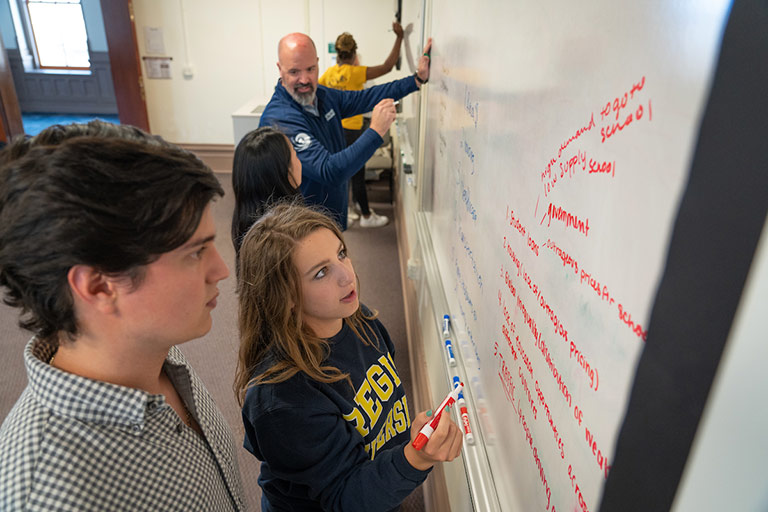 students-whiteboarding-with-professor-768x512.jpg