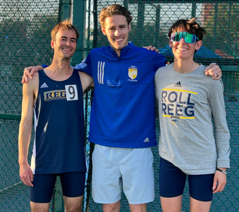 Three students pose together for a photo wearing Regis gear